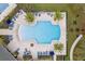 An aerial view showcases the community pool, lounge chairs, tables, and landscaping at 4591 Gliding Wave St, Winter Garden, FL 34787
