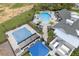 Birds eye view of community pool, splashpad, seating areas, and clubhouse with lush landscaping at 4591 Gliding Wave St, Winter Garden, FL 34787