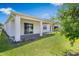 A spacious backyard with healthy green grass and a covered patio is ideal for outdoor relaxation at 4591 Gliding Wave St, Winter Garden, FL 34787