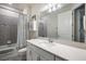 Bathroom featuring a white vanity, shower, and a large mirror at 4591 Gliding Wave St, Winter Garden, FL 34787