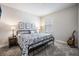 Cozy bedroom with an iron bed frame and natural light from the window at 4591 Gliding Wave St, Winter Garden, FL 34787