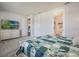 Bright bedroom featuring a comfy bed, TV, and ensuite bathroom entrance at 4591 Gliding Wave St, Winter Garden, FL 34787