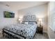 Bedroom featuring a decorative bed, side tables, and natural lighting at 4591 Gliding Wave St, Winter Garden, FL 34787
