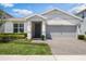 Charming single Gathering home featuring a manicured lawn and covered front entryway at 4591 Gliding Wave St, Winter Garden, FL 34787