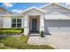 Inviting home featuring a covered entryway and beautiful, low-maintenance landscaping at 4591 Gliding Wave St, Winter Garden, FL 34787