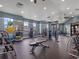 Community gym with modern weightlifting and exercise machines, and ample natural light at 4591 Gliding Wave St, Winter Garden, FL 34787