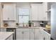 Open kitchen area featuring white cabinets, stainless steel appliances and quartz countertops at 4591 Gliding Wave St, Winter Garden, FL 34787