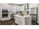 Modern kitchen featuring white cabinets, stainless steel appliances and a kitchen island at 4591 Gliding Wave St, Winter Garden, FL 34787