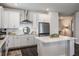 Bright kitchen featuring white cabinets, stainless steel appliances, and hardwood floors at 4591 Gliding Wave St, Winter Garden, FL 34787