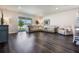 Inviting living room featuring a plush sectional sofa, stylish decor, and dark hardwood flooring at 4591 Gliding Wave St, Winter Garden, FL 34787