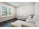 Bright living room featuring hardwood floors, a large window and plush couch at 4591 Gliding Wave St, Winter Garden, FL 34787