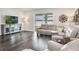Spacious living room with comfortable seating, stylish console, and sliding glass doors to the backyard at 4591 Gliding Wave St, Winter Garden, FL 34787