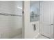 Shower with decorative tiling, glass partition, and a built in shelf at 4591 Gliding Wave St, Winter Garden, FL 34787