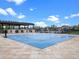 Community splash pad with covered seating, water features, and a playground under a blue sky at 4591 Gliding Wave St, Winter Garden, FL 34787