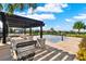 Community splash pad with covered seating, and a view of palm trees under a sunny sky at 4591 Gliding Wave St, Winter Garden, FL 34787