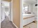 Bright bathroom featuring a vanity with storage, a mirror, and neutral tile at 516 Fort Smith Blvd, Deltona, FL 32738