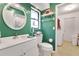 Bright bathroom features a stylish vanity, tile floors, and a window for natural light at 516 Fort Smith Blvd, Deltona, FL 32738