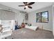 Cozy bedroom featuring carpet flooring, ceiling fan, and a bright window at 516 Fort Smith Blvd, Deltona, FL 32738