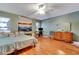 Cozy bedroom with hard wood floors and ceiling fan at 516 Fort Smith Blvd, Deltona, FL 32738