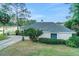Exterior view of the home with a well-manicured lawn and lake views at 516 Fort Smith Blvd, Deltona, FL 32738