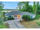 Aerial front exterior with well-manicured lawn and mature landscaping at 516 Fort Smith Blvd, Deltona, FL 32738