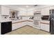 Bright kitchen featuring white cabinets, tile flooring, and modern appliances at 516 Fort Smith Blvd, Deltona, FL 32738