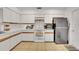 Well-lit kitchen with white cabinets, tile flooring, and modern appliances at 516 Fort Smith Blvd, Deltona, FL 32738