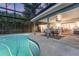 Inviting screened-in pool area with a covered patio and outdoor dining set at 516 Fort Smith Blvd, Deltona, FL 32738