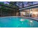 Large screened-in pool with an adjacent patio area perfect for outdoor relaxation at 516 Fort Smith Blvd, Deltona, FL 32738
