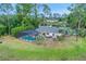 This home boasts a lovely screened-in pool and beautiful mature landscaping at 516 Fort Smith Blvd, Deltona, FL 32738