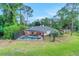 Home aerial view featuring a screened-in pool and lush backyard with lake views at 516 Fort Smith Blvd, Deltona, FL 32738