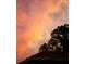 Gorgeous sunset with hues of orange and pink highlighting puffy clouds at 516 Fort Smith Blvd, Deltona, FL 32738