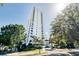 Stunning high-rise condo building showcasing modern architecture and lush landscaping on a sunny day at 530 E Central Blvd # 1702, Orlando, FL 32801