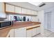 Cozy kitchen featuring granite countertops, white cabinets, and a pass-through to the living area at 530 E Central Blvd # 1702, Orlando, FL 32801