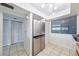 Bright kitchen featuring stainless steel refrigerator and ample storage with multiple pantries at 530 E Central Blvd # 1702, Orlando, FL 32801