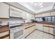 Traditional kitchen with white appliances, wood-trimmed cabinets, and a charming pass-through window at 530 E Central Blvd # 1702, Orlando, FL 32801