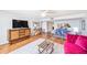 Spacious living room showcasing hardwood floors, custom furniture, and open access to kitchen at 530 E Central Blvd # 1702, Orlando, FL 32801