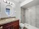 Stylish bathroom with granite vanity and updated tiled walk-in shower at 5481 Nokomis Cir, Orlando, FL 32839