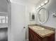 Granite vanity, updated fixtures, and new mirror create an inviting atmosphere at 5481 Nokomis Cir, Orlando, FL 32839
