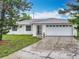 Charming home with a well-manicured lawn and a two-car garage at 5481 Nokomis Cir, Orlando, FL 32839