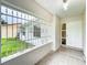 View of front porch with tiled floor, decorative bars, and the home's front door at 5481 Nokomis Cir, Orlando, FL 32839