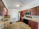 Kitchen featuring granite countertops, stainless steel appliances, and wood cabinets at 5481 Nokomis Cir, Orlando, FL 32839