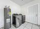 Laundry room with new washer/dryer and hot water tank at 5481 Nokomis Cir, Orlando, FL 32839