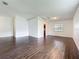 Large living room featuring dark wood floors, neutral walls, and plenty of natural light at 5481 Nokomis Cir, Orlando, FL 32839