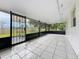 Large screened porch overlooking expansive yard and lush greenery, perfect for relaxation at 5481 Nokomis Cir, Orlando, FL 32839