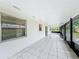 Extended screened porch with neutral tile, providing ample space for outdoor enjoyment at 5481 Nokomis Cir, Orlando, FL 32839