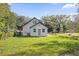 Home featuring a manicured backyard with lush green grass and trees at 600 Lakewood Ave, Ocoee, FL 34761