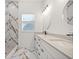 Bathroom featuring a double vanity, marble floors, and marble tiled shower at 600 Lakewood Ave, Ocoee, FL 34761