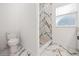 Bathroom featuring marble floors and a shower with marble walls at 600 Lakewood Ave, Ocoee, FL 34761