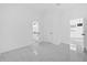 View of bathroom with white marble floors, white cabinetry and a view to the living room at 600 Lakewood Ave, Ocoee, FL 34761
